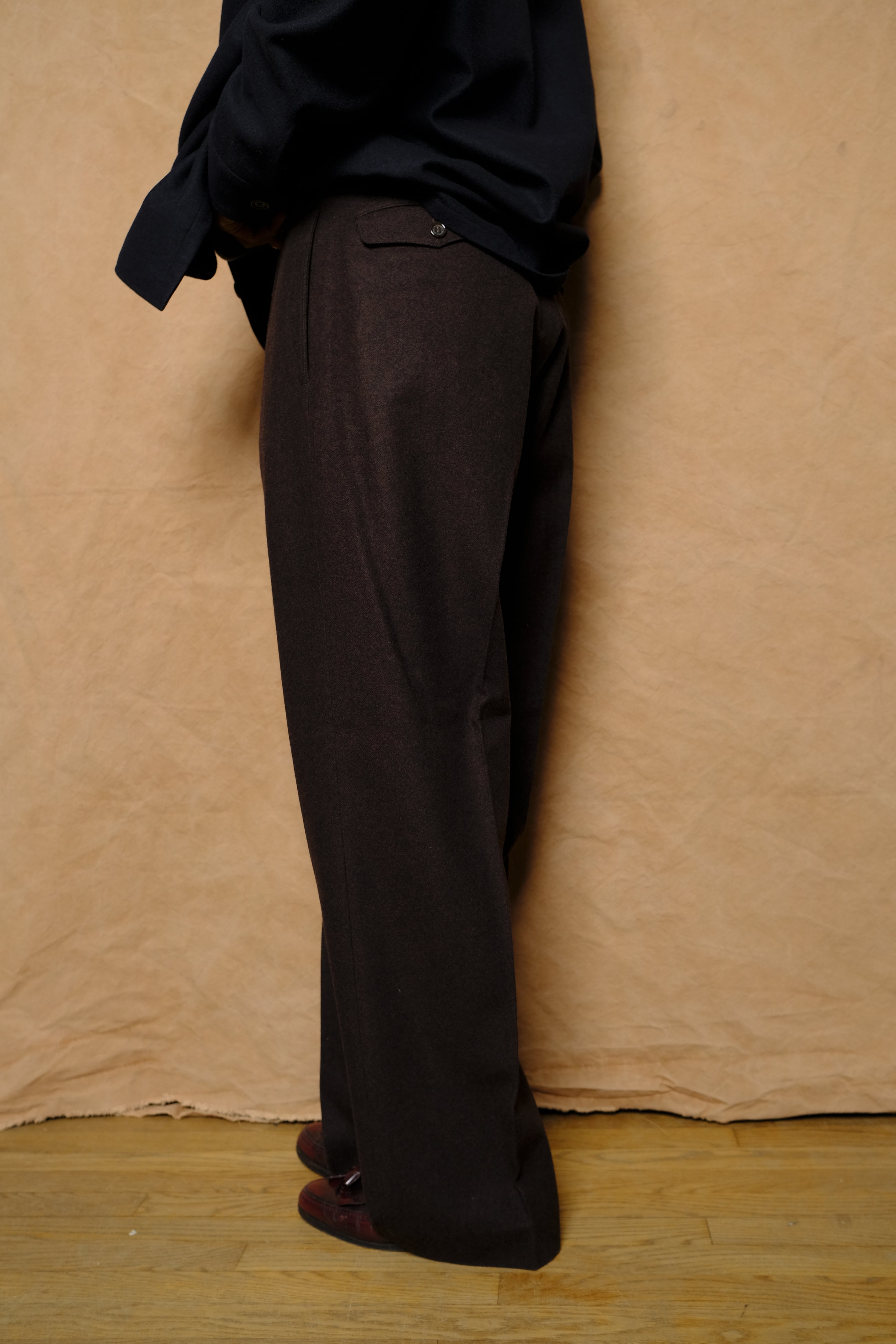 in tuck trousers in dark brown powder melton wool