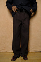 in tuck trousers in dark brown powder melton wool